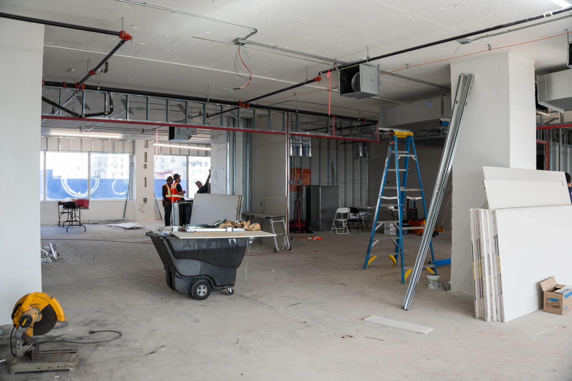Unfinished interior partitions, a materials cart and overhead services at 100 Biscayne